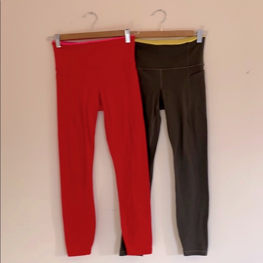 Red pair Athleta Revelation laser cut leggings, XS